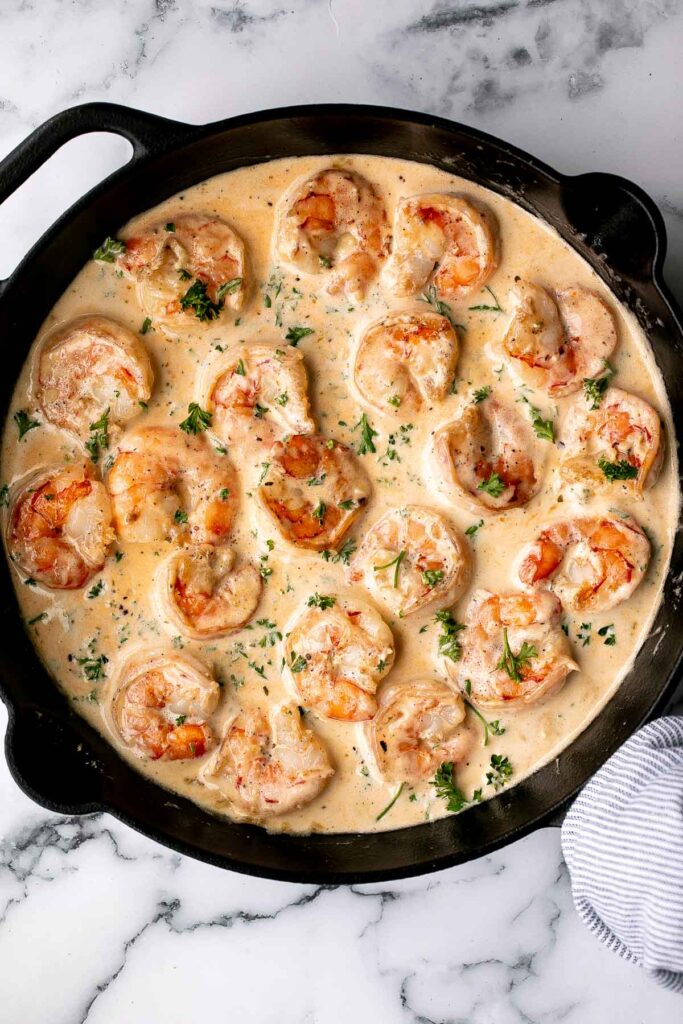 Delicious Creamy Garlic Shrimp in a skillet with fresh parsley