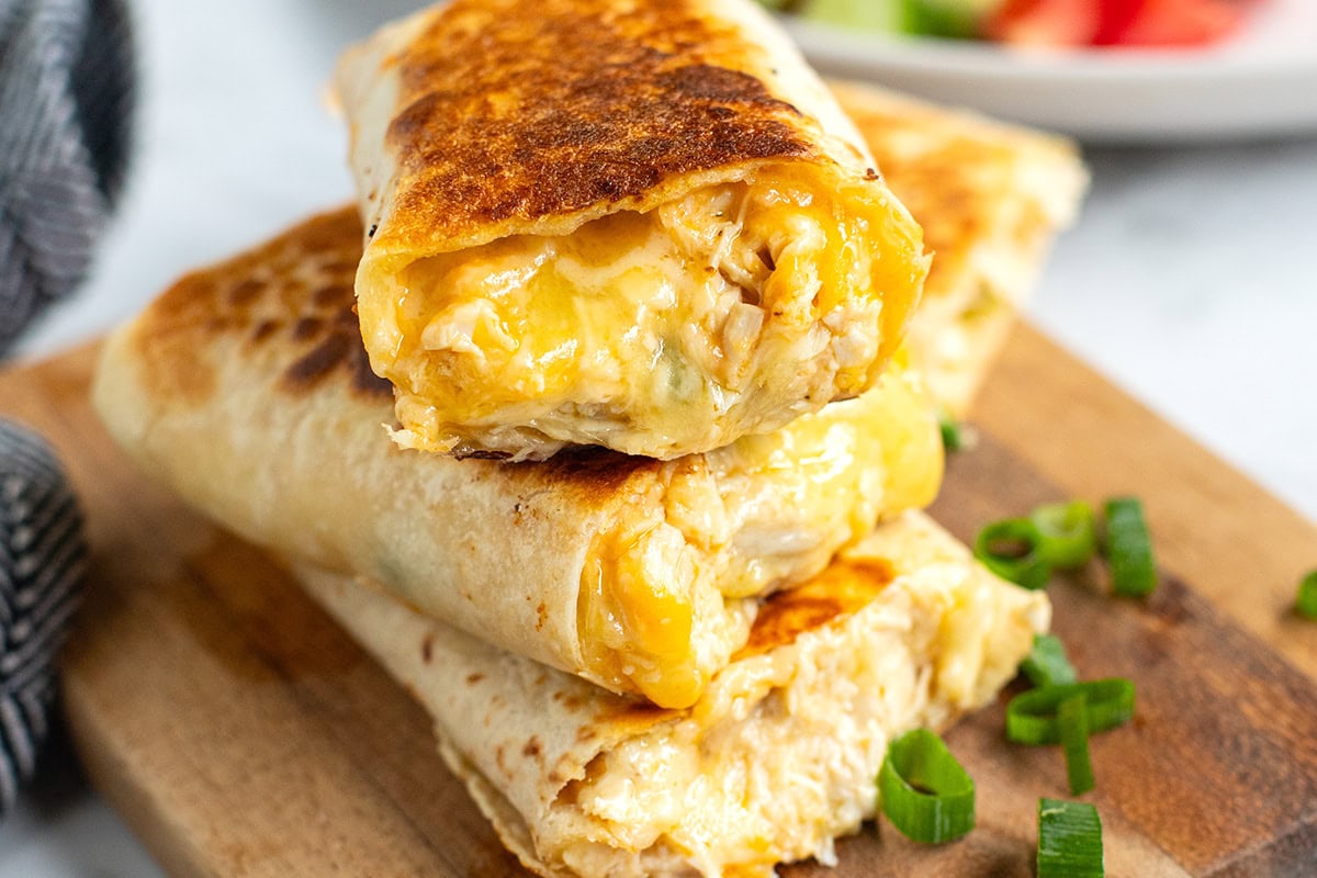 Cheesy Garlic Chicken Wraps on a cutting board